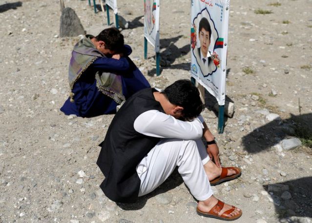 Relatives gather at a graveyard of the victims who were killed in a suicide attack in an educational centre two years ago, as Afghan government officials and the Taliban hold talks in Doha aimed at ending 19 years of war in the country, in Kabul, Afghanistan September 14, 2020. REUTERS
